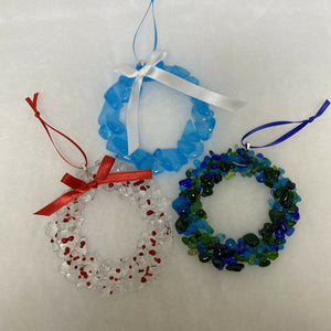 Fused glass Christmas wreaths and assorted ornaments.