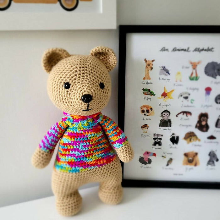 Tan bear with rainbow sweater